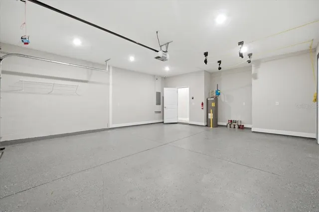 an empty room with an entryway and a ceiling fan