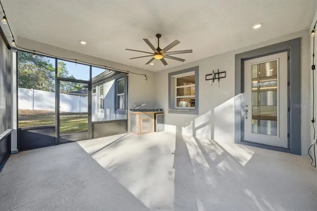 a view of an empty room with window and a livingroom