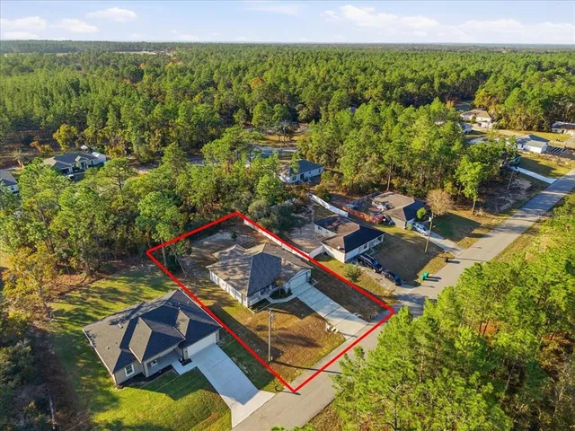 an aerial view of a house with a big yard