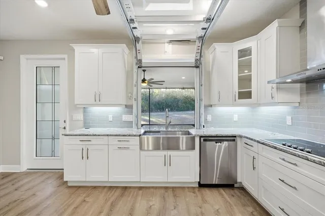 a kitchen with a stove and white cabinets