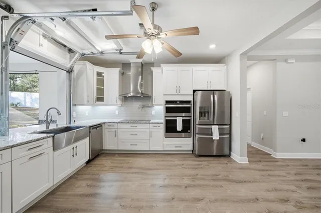 a large kitchen with cabinets and stainless steel appliances