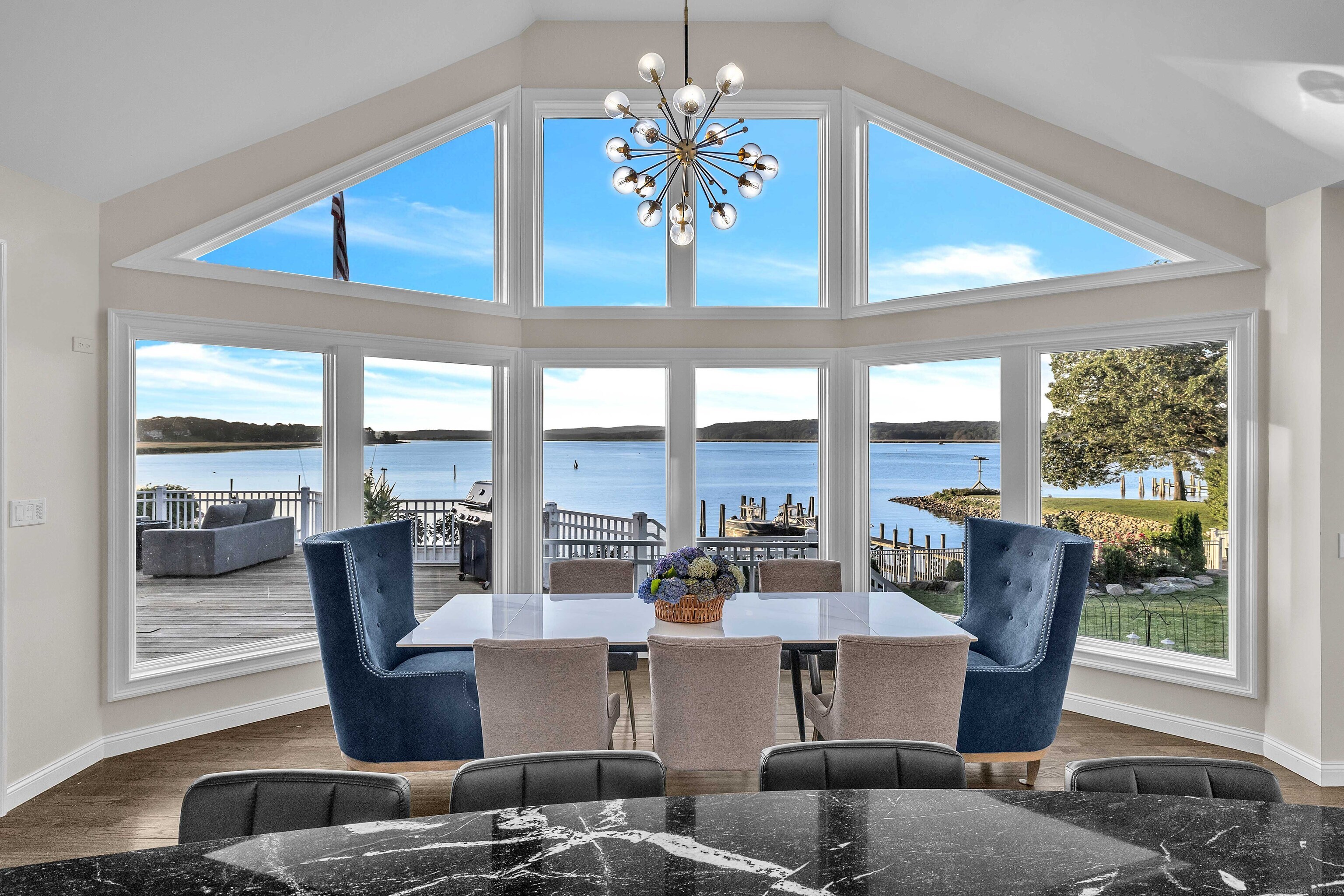 12 Rocky Point Road Old Saybrook, CT 06475 - Photo 6 of 28 a living room with furniture and large windows