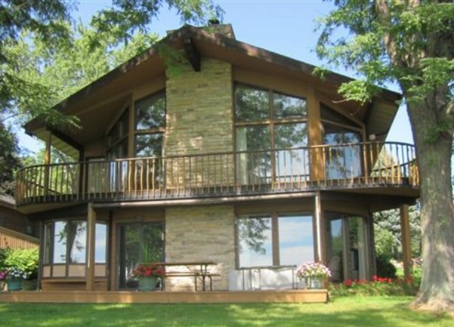 858 Breckenboro Road Lake Summerset, IL 61019 - Photo 1 of 24 a front view of a house with a yard table and chairs