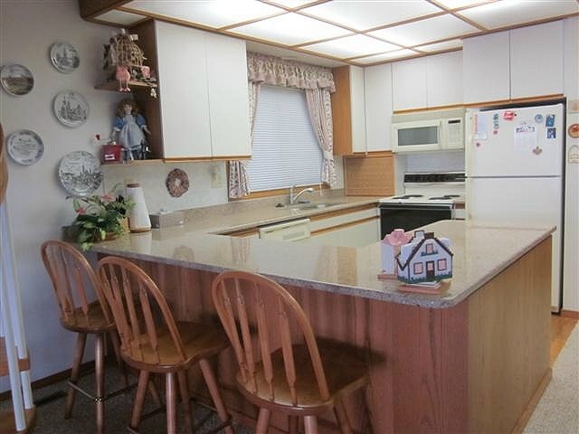 858 Breckenboro Road Lake Summerset, IL 61019 - Photo 4 of 24 a kitchen with stainless steel appliances granite countertop a sink and a refrigerator