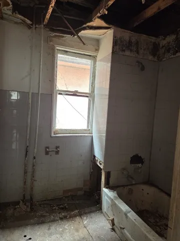 a bathroom with a bathtub and shower