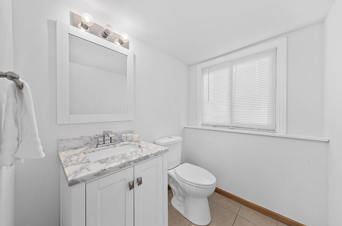 29-w045 Wagner Road Naperville, IL 60564 - Photo 24 of 34 a bathroom with a granite countertop sink a toilet and a mirror