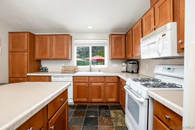 a kitchen with stainless steel appliances a stove sink and cabinets