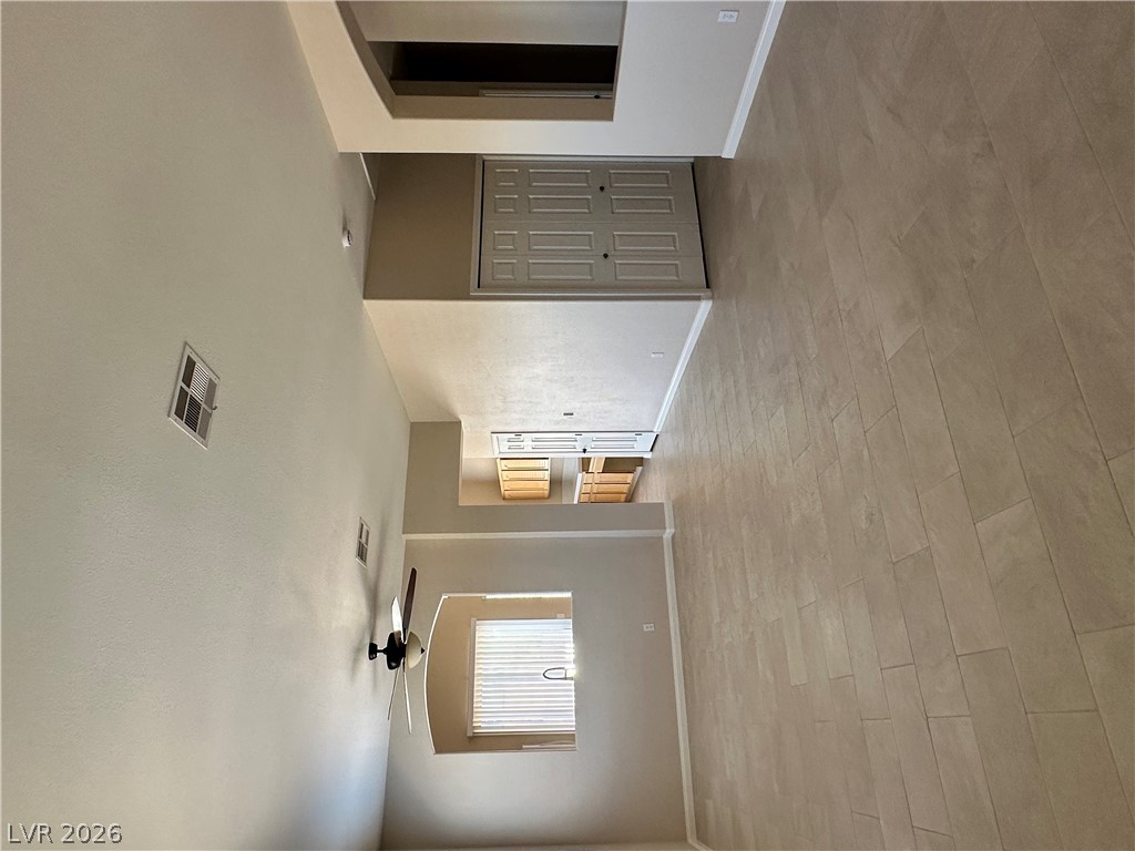 1922 Thunder Ridge Circle Henderson, NV 89012 - Photo 4 of 27 Clean, neutral-toned flooring stretches through this well-lit interior, leading towards a functional laundry area.