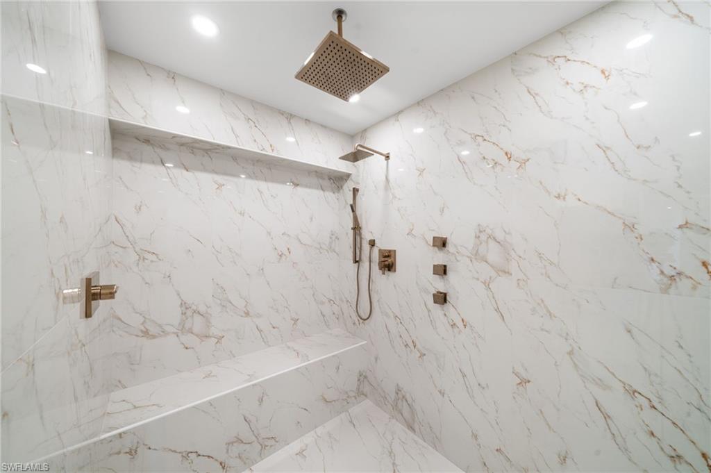 4451 Gulf Shore Boulevard North, Unit 2002 Naples, FL 34103 - Photo 19 of 36 a bathroom with a shower