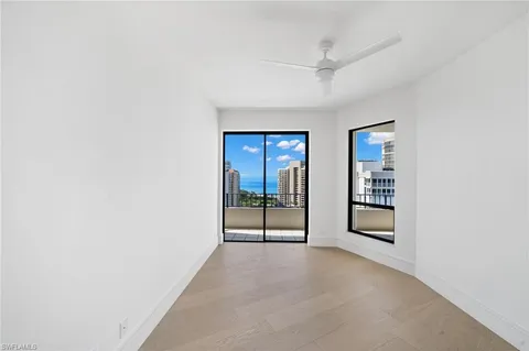 an empty room with windows and closet
