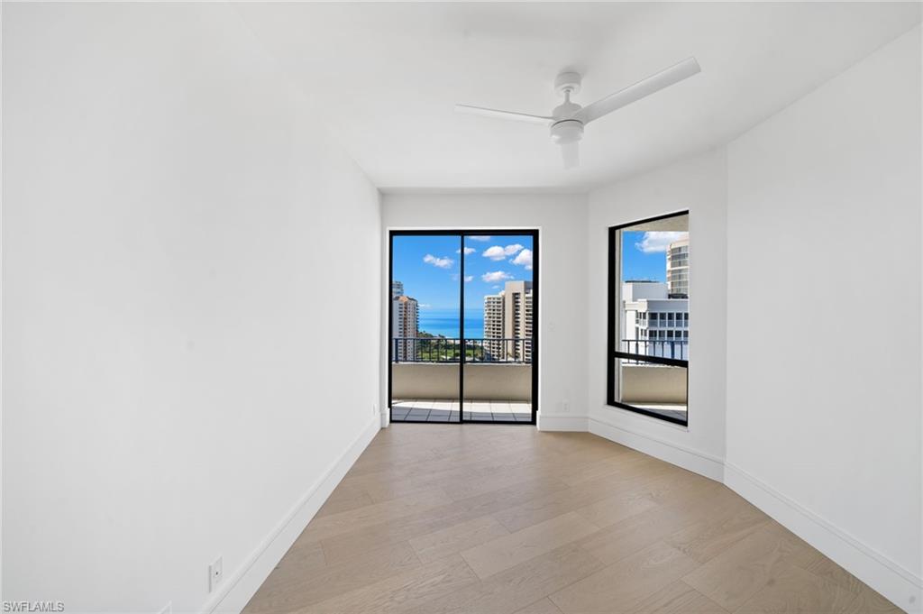 4451 Gulf Shore Boulevard North, Unit 2002 Naples, FL 34103 - Photo 23 of 36 an empty room with windows and closet
