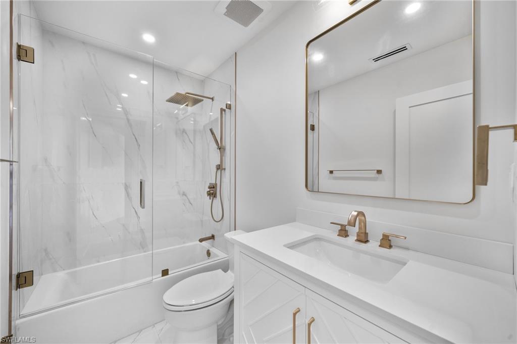 4451 Gulf Shore Boulevard North, Unit 2002 Naples, FL 34103 - Photo 25 of 36 a bathroom with a sink a toilet and shower