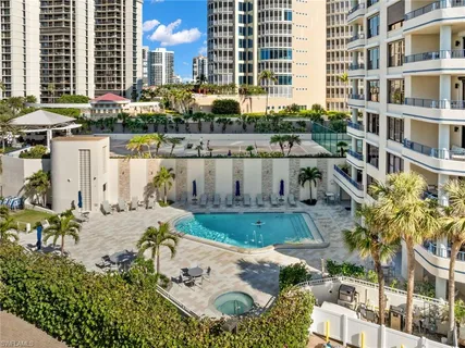 a view of a swimming pool with outdoor seating and plants