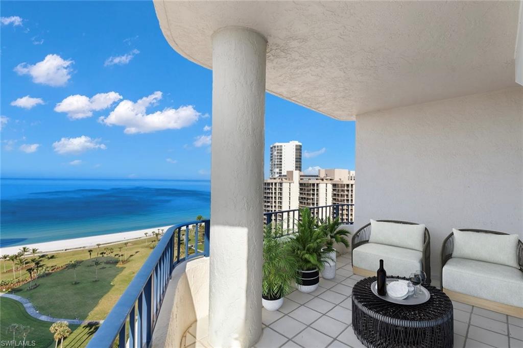 4451 Gulf Shore Boulevard North, Unit 2002 Naples, FL 34103 - Photo 3 of 36 a balcony with outdoor seating and plants