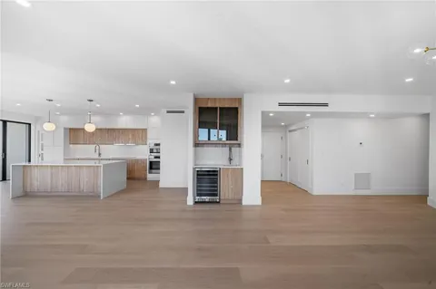 a view of kitchen with refrigerator and window