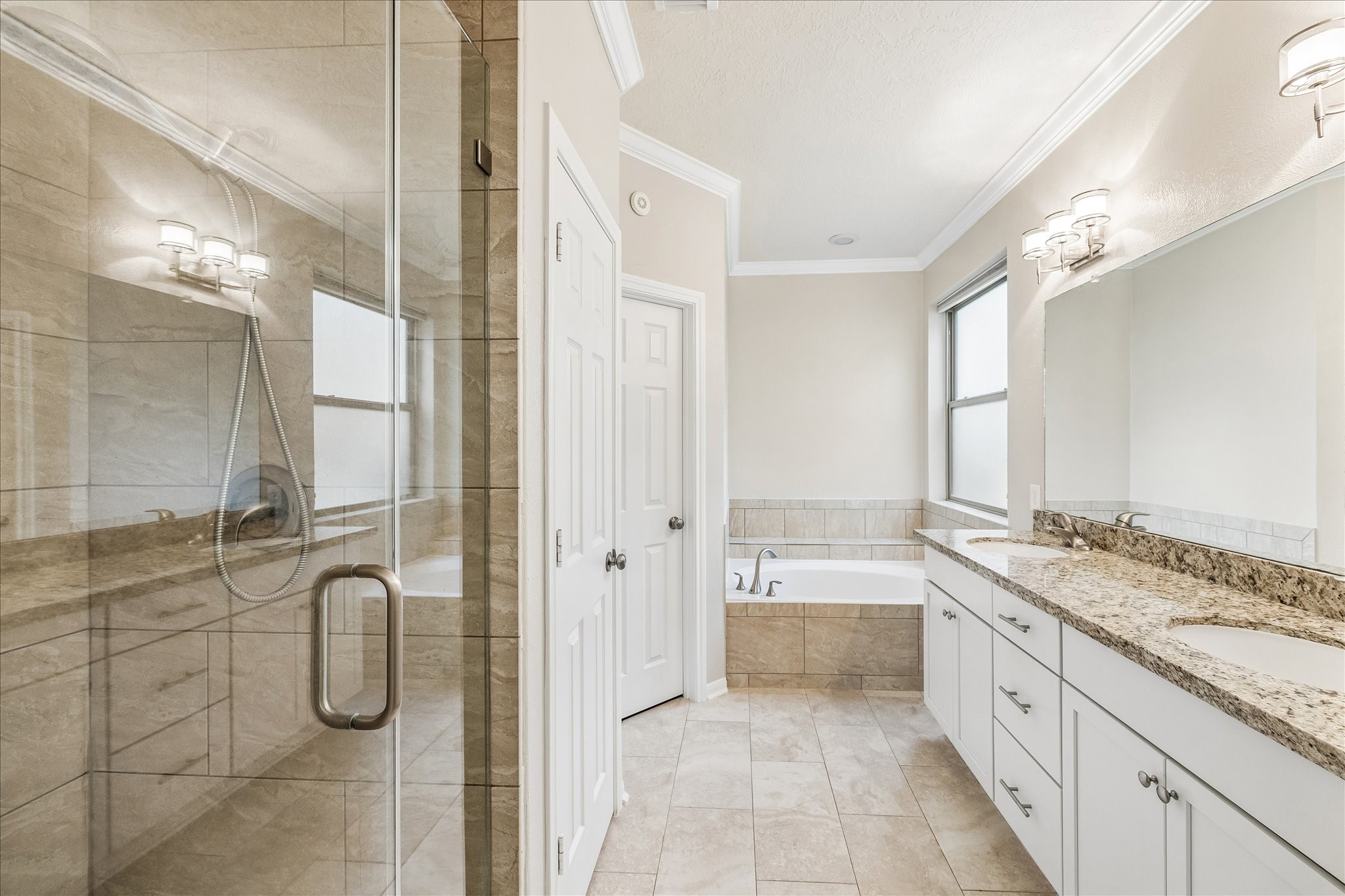 5811 Walkabout Way Katy, TX 77450 - Photo 17 of 33 Spacious primary bath featuring dual vanities, a soaking tub, separate shower, and generous storage.