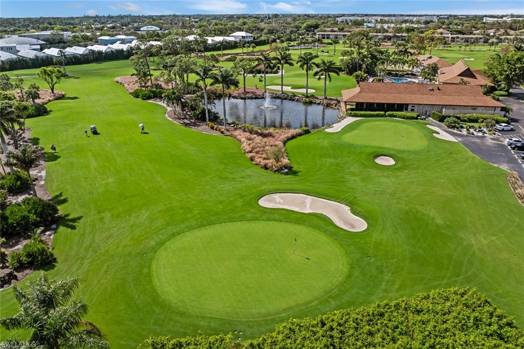 136 Harrison Road, Unit 1 Naples, FL 34112 - Photo 27 of 29 Expansive golf course featuring a green, sand traps, and a water hazard with a fountain