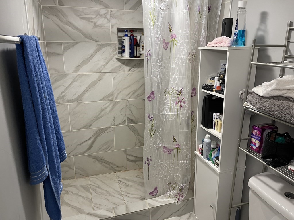 51 Pleasant Street Ware, MA 01082 - Photo 13 of 17 a bathroom with a sink and a shower