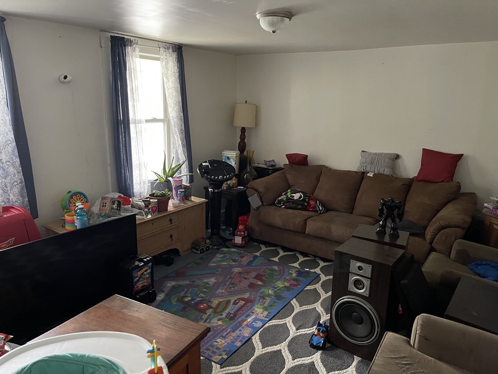 51 Pleasant Street Ware, MA 01082 - Photo 15 of 17 a living room with furniture and wooden floor