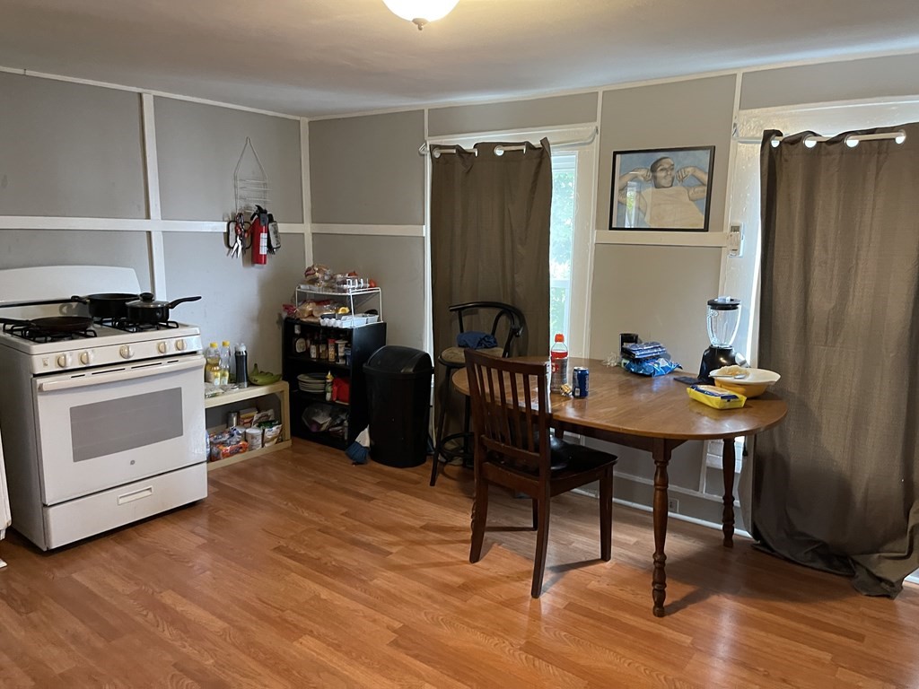 51 Pleasant Street Ware, MA 01082 - Photo 16 of 17 a kitchen with stainless steel appliances wooden floor and chairs