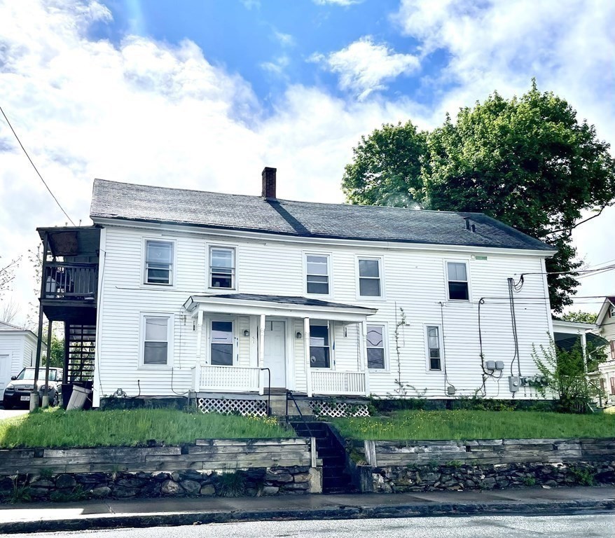 51 Pleasant Street Ware, MA 01082 - Photo 3 of 17 a view of white house with a yard and potted plants
