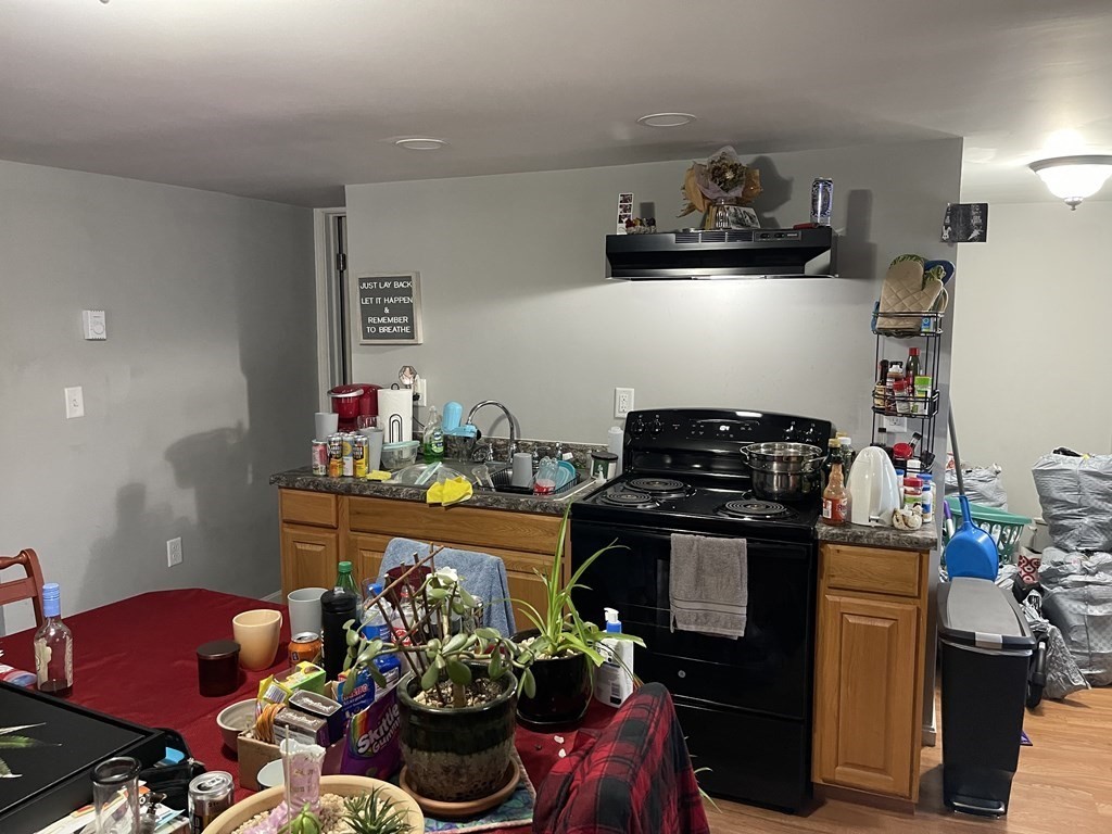 51 Pleasant Street Ware, MA 01082 - Photo 9 of 17 a kitchen with a stove and a refrigerator