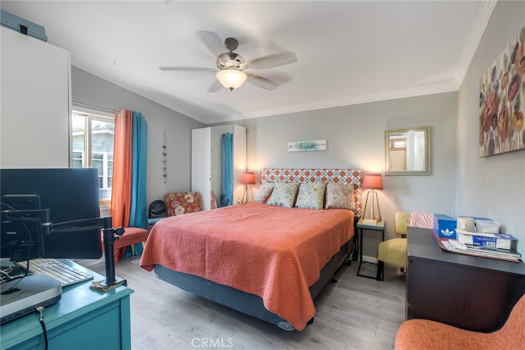 3909 Reche Road, Unit 125 Fallbrook, CA 92028 - Photo 20 of 58 a bedroom with a bed and a chandelier