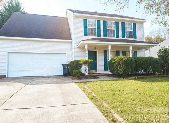 a view of house with swimming pool outdoor seating