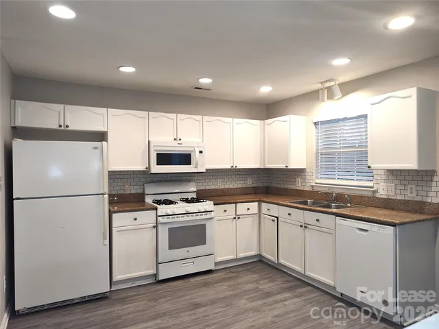 a kitchen with a white cabinets and white appliances