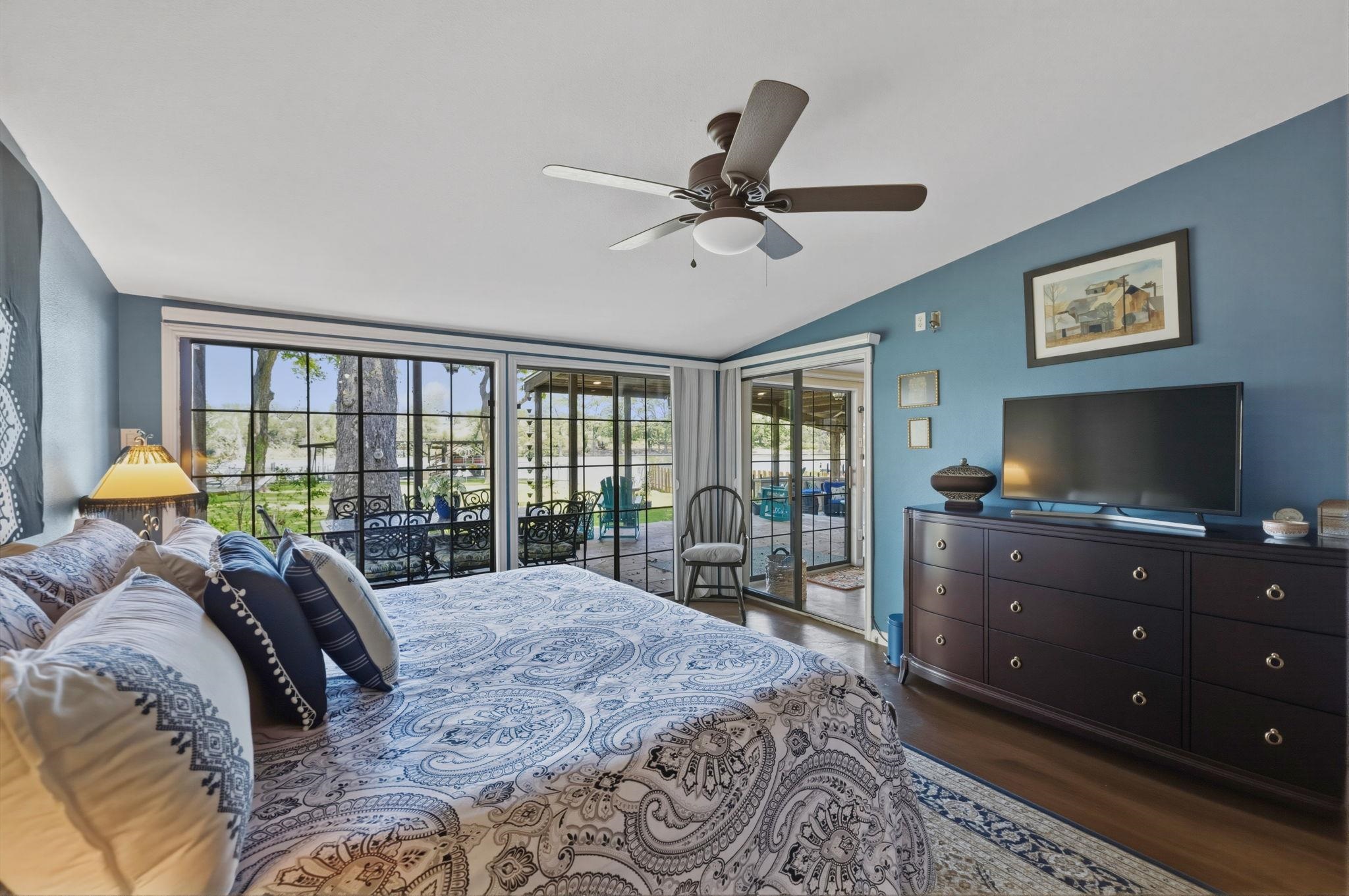 1435 East Zipp Road New Braunfels, TX 78130 - Photo 24 of 43 a bedroom with a bed flat screen tv and a large window