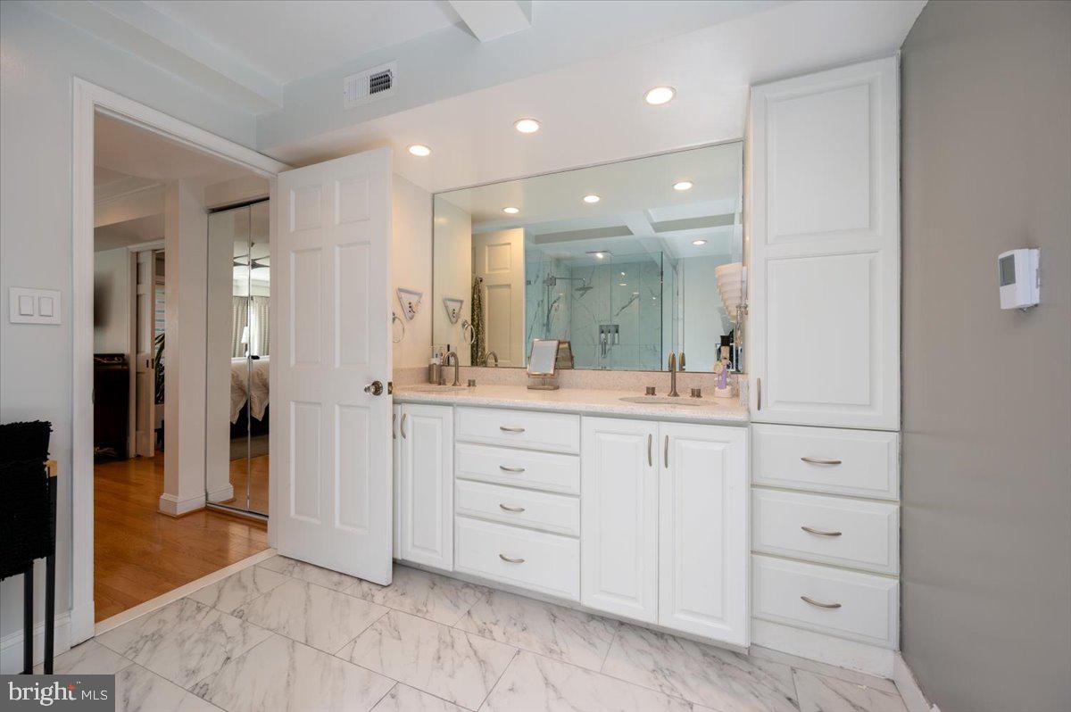 2125 Quay Village Court, Unit T1 Annapolis, MD 21403 - Photo 20 of 36 a bathroom with a shower sink and mirror
