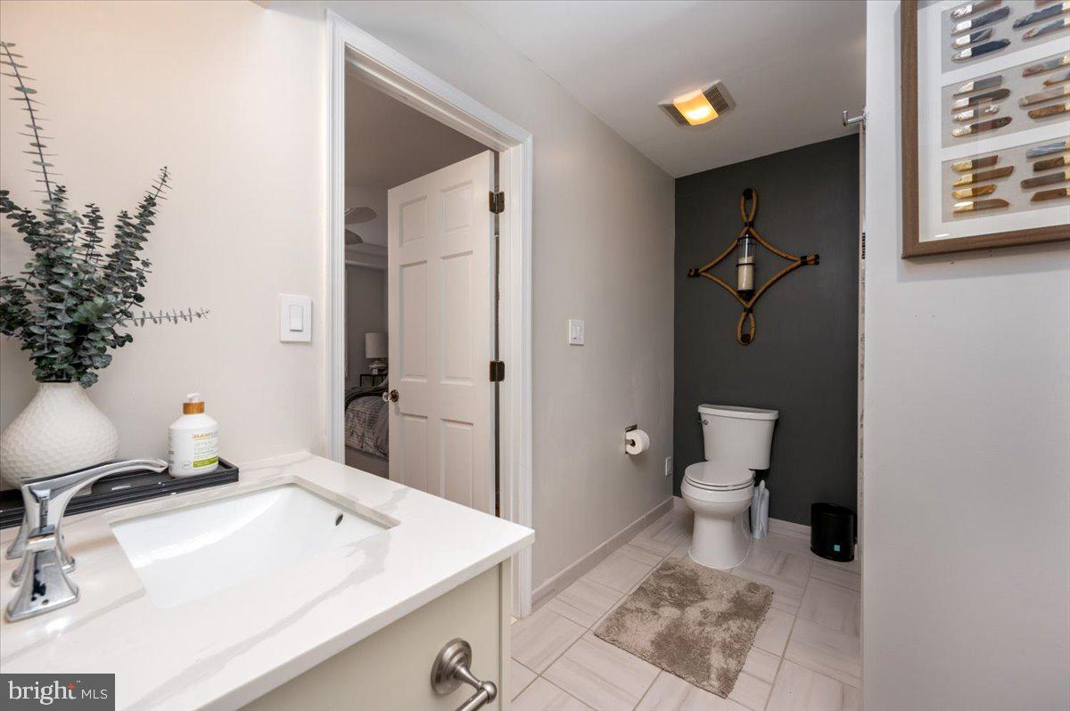 2125 Quay Village Court, Unit T1 Annapolis, MD 21403 - Photo 22 of 36 a bathroom with a sink toilet and vanity