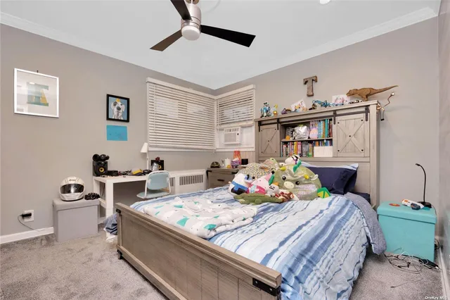 a blue bed sitting in a bedroom next to a window