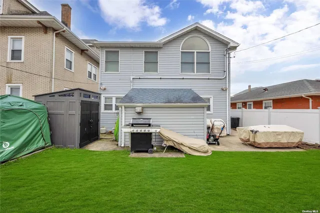 a view of a house with a yard and sitting area