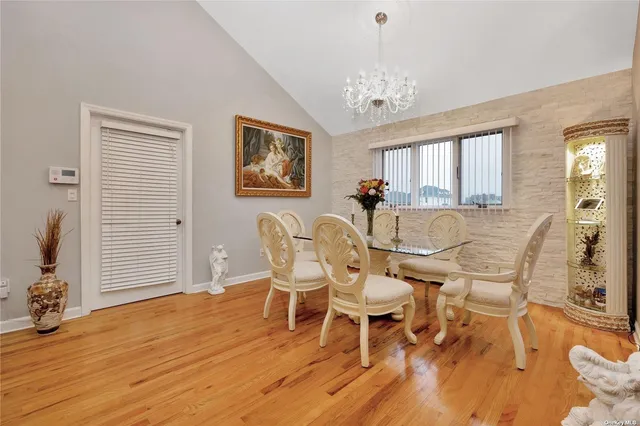 a view of a dining room with furniture and chandelier