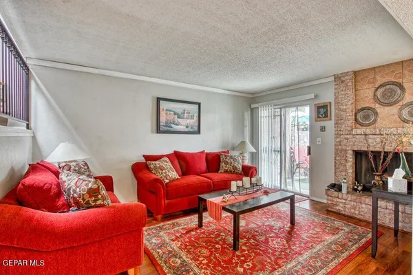 a living room with furniture a rug and a fireplace