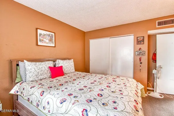 a bedroom with a bed and a dresser