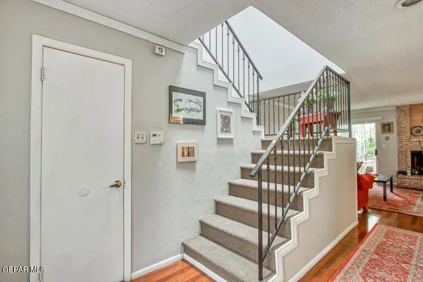 a view of entryway and hall with wooden floor
