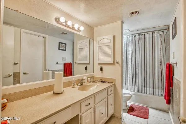 a bathroom with a tub sink and a mirror