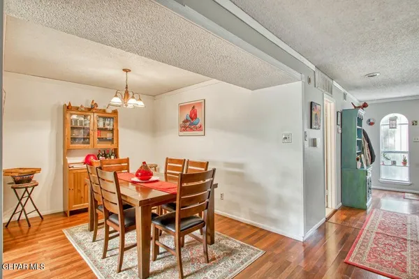 a view of a dining room with furniture and wooden floor