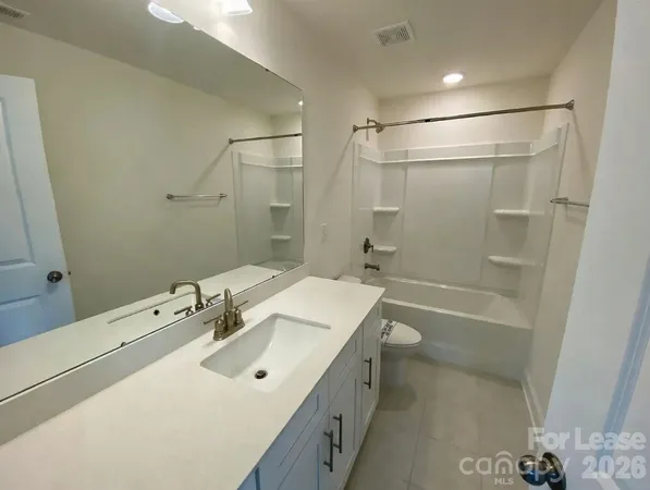 a bathroom with a tub a sink and a shower