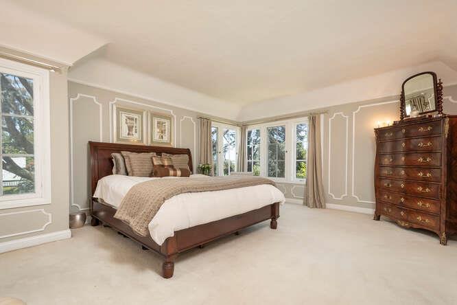 315 Arden Road Hillsborough, CA 94010 - Photo 17 of 31 a bed sitting in a bedroom next to a window and dresser