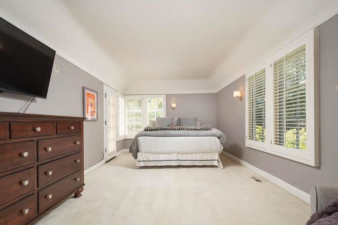 315 Arden Road Hillsborough, CA 94010 - Photo 19 of 31 a spacious bedroom with a bed and a flat screen tv