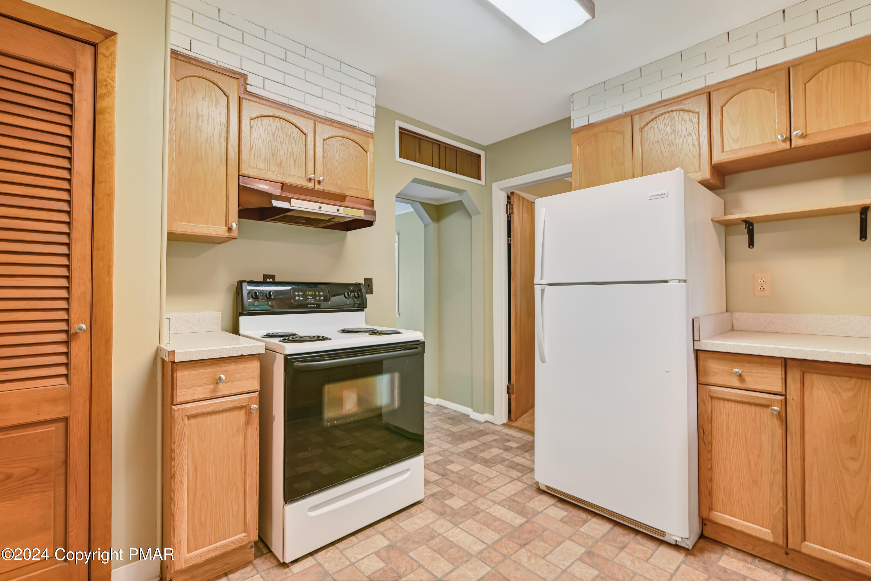 205 Aspen Road Dingmans Ferry, PA 18328 - Photo 13 of 29 a kitchen with stainless steel appliances granite countertop a refrigerator a stove and a sink with cabinets