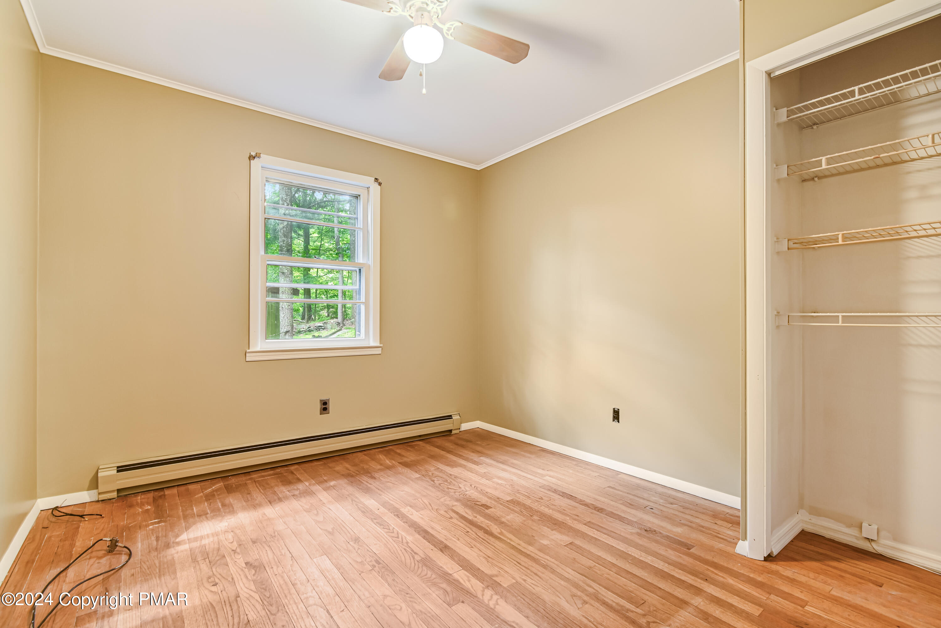 205 Aspen Road Dingmans Ferry, PA 18328 - Photo 21 of 29 a view of empty room with wooden floor and fan