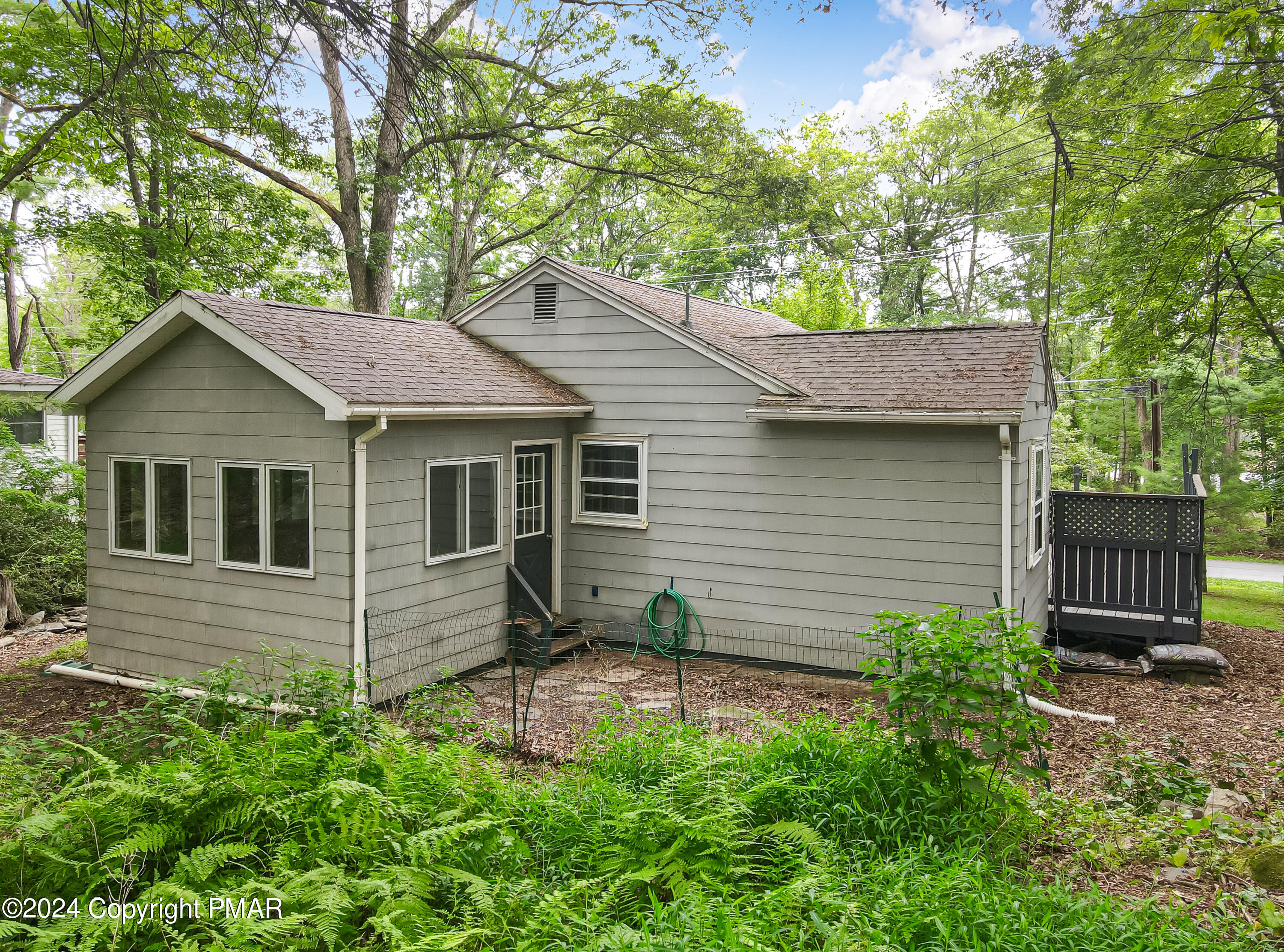 205 Aspen Road Dingmans Ferry, PA 18328 - Photo 27 of 29 a view of a house with a yard plants and large tree