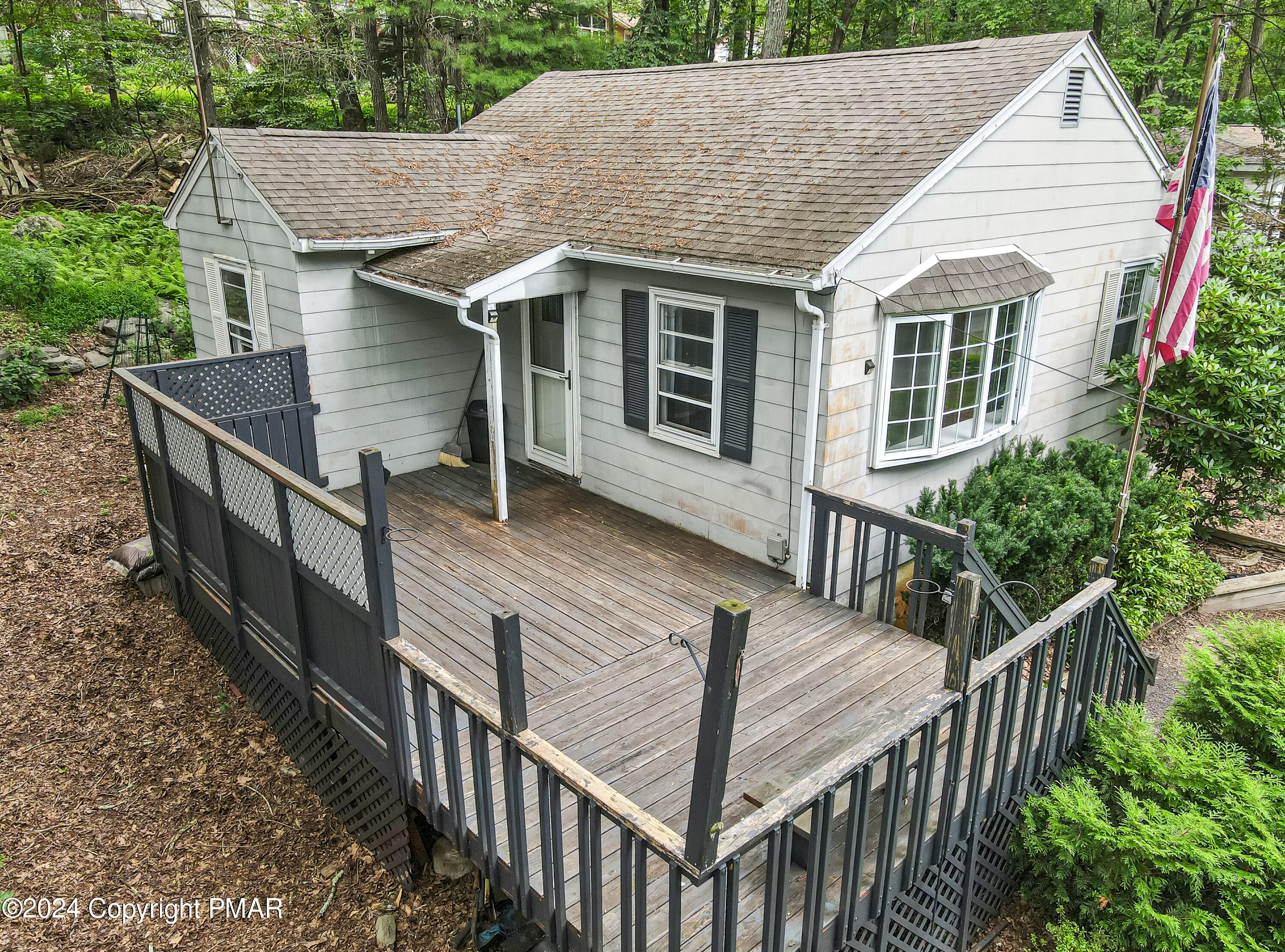 205 Aspen Road Dingmans Ferry, PA 18328 - Photo 5 of 29 a view of house with wooden deck and furniture