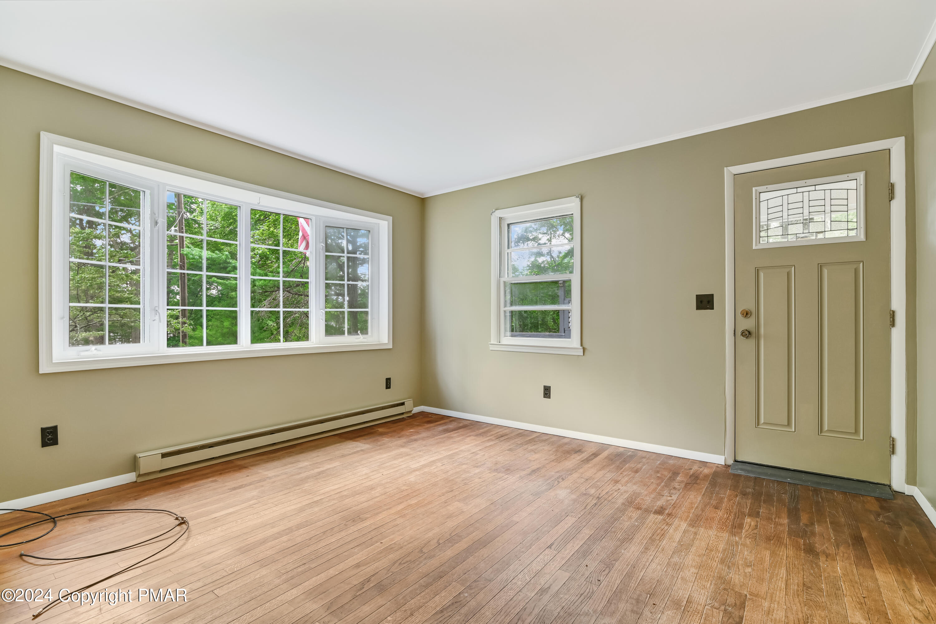 205 Aspen Road Dingmans Ferry, PA 18328 - Photo 6 of 29 a view of an empty room with wooden floor and a window