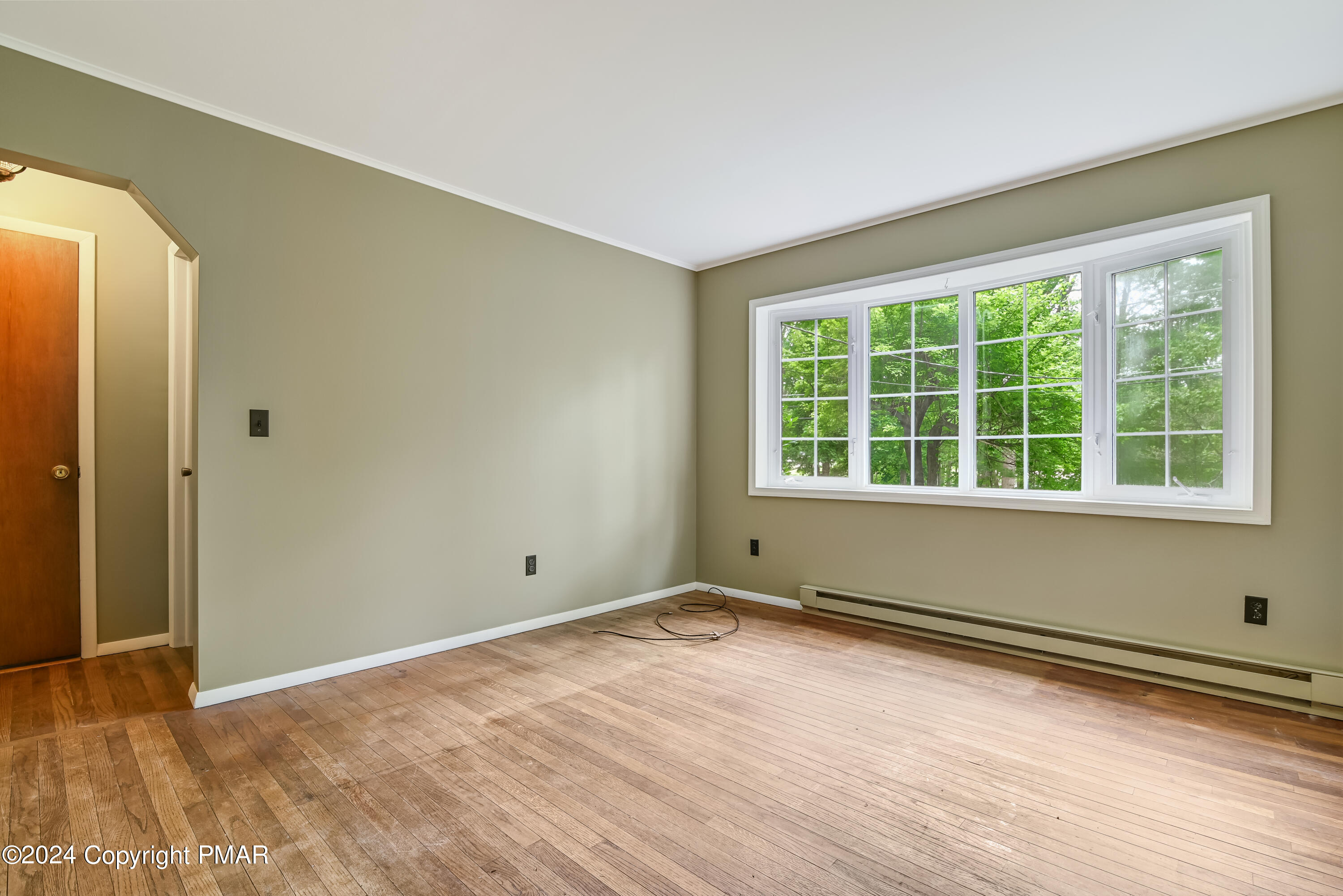 205 Aspen Road Dingmans Ferry, PA 18328 - Photo 8 of 29 a view of empty room with wooden floor and fan