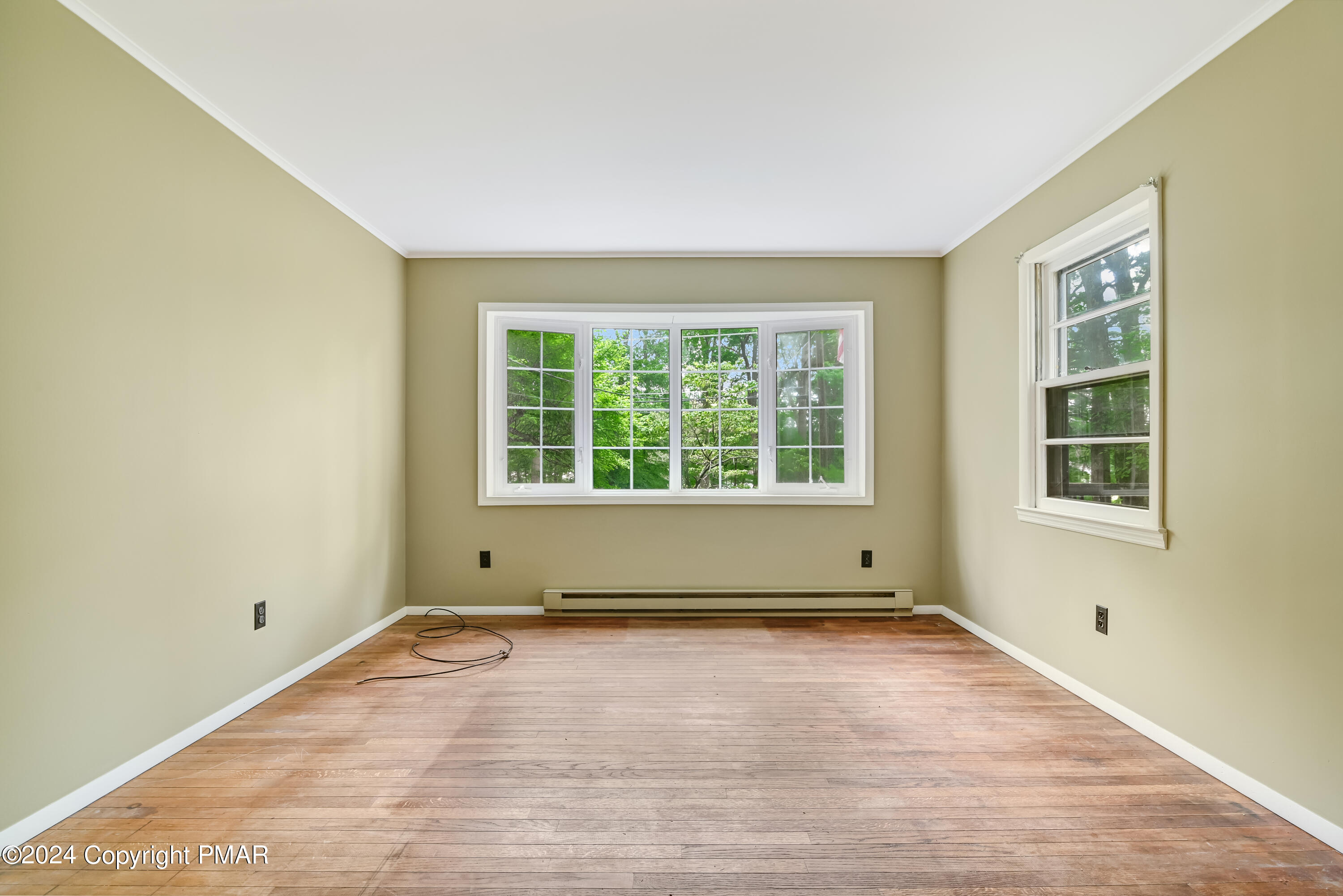 205 Aspen Road Dingmans Ferry, PA 18328 - Photo 9 of 29 an empty room with wooden floor and windows